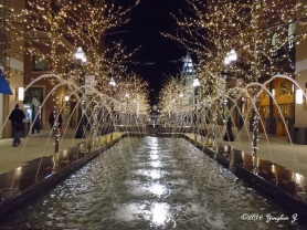A walk by the fountain under festive lights.